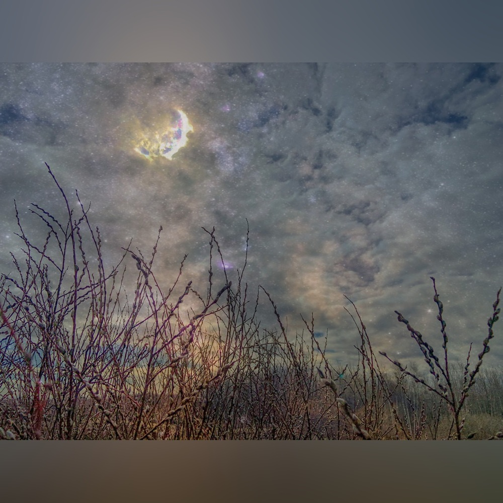 Ominous moon appearing at dusk November rain wheat field digital photography